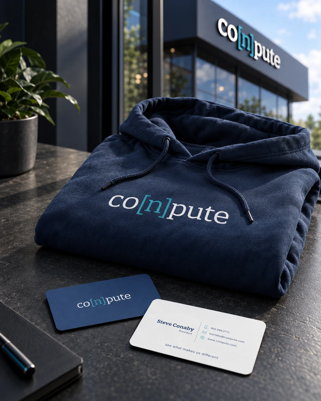 Conpute branded hoodie and business cards with matching office signage